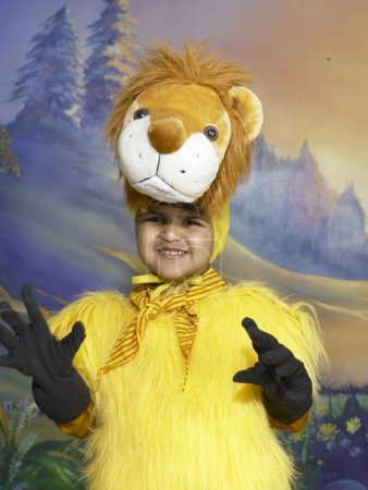 Photo for South Asian Indian boy dressed as lion performing fancy dress competition on stage in nursery school - Royalty Free Image