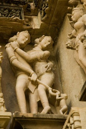 Photo for Erotic sculpture of young couple teasing monkey at Lakshmana temple of Khajuraho , Madhya Pradesh , India - Royalty Free Image