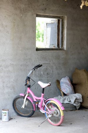 Photo for Baby bicycle stand near a window, India - Royalty Free Image