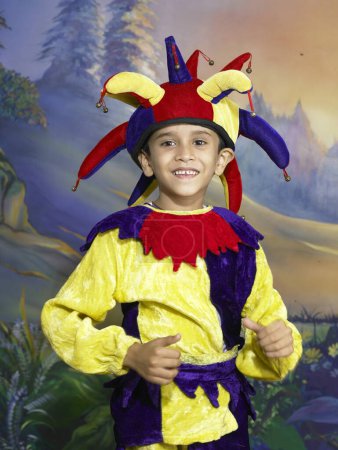 Photo for South Asian Indian boy dressed as joker performing fancy dress competition on stage in nursery school - Royalty Free Image