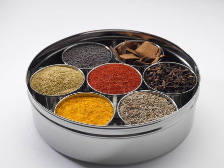 Photo for Different types of spices in bowls in stainless steel box on white background - Royalty Free Image