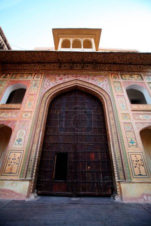 Photo for Wooden door with small entry door of Amber as Amer fort in 1592 , Jaipur , Rajasthan in India - Royalty Free Image