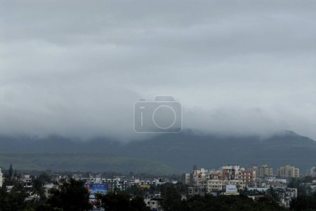 Aerial View of Pune city with Grey Clouds on Sahyadri Mountain in Rainy season and Buildings at Sinhgarh Road, Pune, Maharashtra, India, Asia 