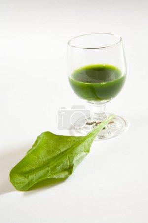 Green vegetable spinach juice against white background , palak ka rus , India