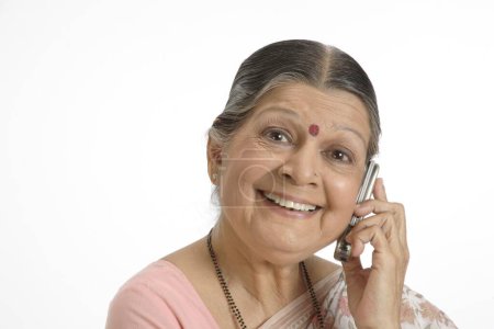 Old lady talking on mobile with smiling face