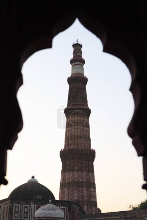Photo for Sunset at Qutab Minar built in 1311 red sandstone tower , Indo_Muslim art , Delhi sultanate , Delhi, India UNESCO World Heritage Site - Royalty Free Image