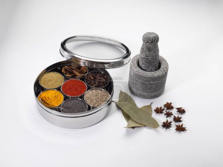 Photo for Different types of spices in bowls in stainless steel box with old stone grinder - Royalty Free Image