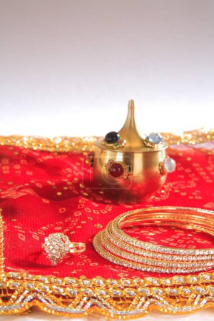 Téléchargez les photos : Festival indien Procession de célébration Teej pour la déesse Parvati anneau de pot de chunari kumkum rouge et bracelets sur fond blanc, Inde - en image libre de droit
