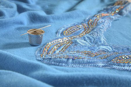Concept , thimble with needle kadhai art of embroidery on cloth