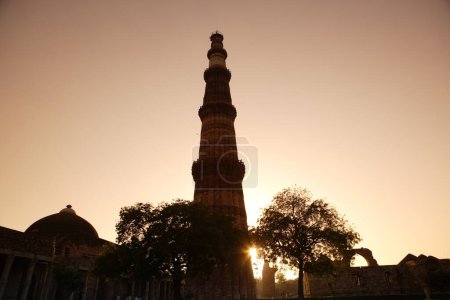 Photo for Sunset at Qutab Minar built in 1311 red sandstone tower , Indo_Muslim art , Delhi sultanate , Delhi, India UNESCO World Heritage Site - Royalty Free Image