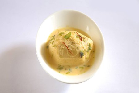 Photo for Indian sweet , kesar rasmalai garnish with pistachio and saffron served in bowl - Royalty Free Image