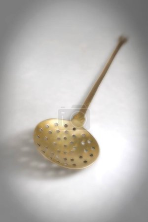 Photo for Kitchen things , skimmer of brass on white background - Royalty Free Image