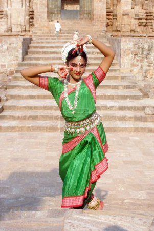 Photo for Dancer performing classical traditional odissi dance in front of Konarak Sun temple, Konarak, Orissa, India - Royalty Free Image