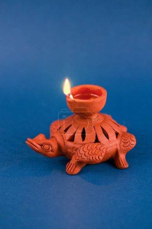 Oil lamp on blue background, India