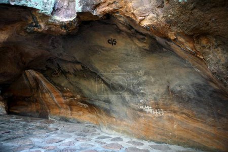 Photo for Cave paintings showing men with arms on rock shelters no 5 ten thousands years old at Bhimbetka near Bhopal , Madhya Pradesh , India - Royalty Free Image