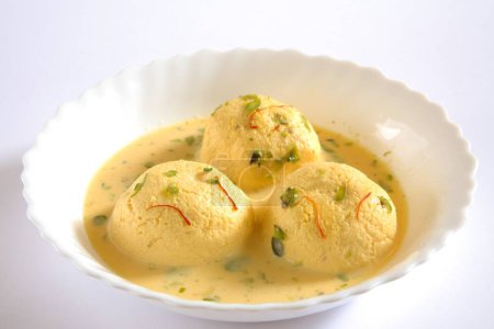 Photo for Indian sweet , kesar rasmalai garnish with pistachio and saffron served in bowl - Royalty Free Image