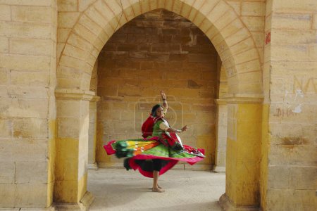 Photo for Lady dancing at Gadsisar Gadisar lake structure, Jaisalmer, Rajasthan, India - Royalty Free Image