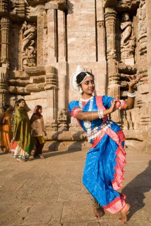 Photo for Odissi dancer strike pose re-enacts Indian myths such as Ramayana in front of world heritage Sun temple complex in Konarak, Orissa, India - Royalty Free Image
