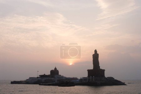 Photo for Sunrise behind Swami Vivekananda Rock Memorial and Thiruvalluvar statue immortal poet , Kanyakumari , Tamil Nadu , India - Royalty Free Image
