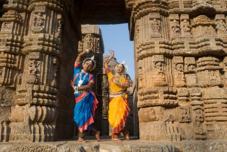 Photo for Odissi dancers strike pose re-enacts Indian myths such as Ramayana in front of world heritage Sun temple complex in Konarak, Orissa, India - Royalty Free Image