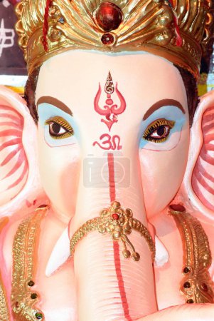 Close up of lord ganesh elephant headed god om and trishul painted on forehead for Ganpati festival year 2008 at Borivali , Bombay Mumbai , Maharashtra , India