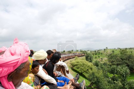 Photo for People sitting on train roof, Rajasthan, India - Royalty Free Image