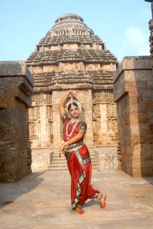 Photo for Dancer performing classical traditional odissi dance in front of Konarak Sun temple, Konarak, Orissa - Royalty Free Image
