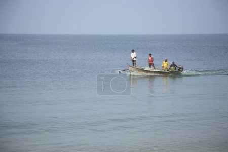 Photo for Fishermen standing in boat in Arabian Sea at Shiroda , Velagar , Maharashtra , West coast , India , fisher men with boat - Royalty Free Image