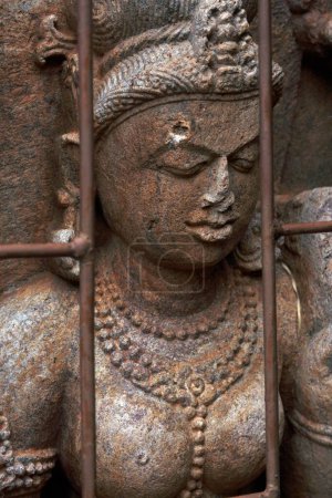Téléchargez les photos : Statue derrière un bar en métal dans un site archéologique bouddhiste, Udayagiri, Orissa, Inde - en image libre de droit