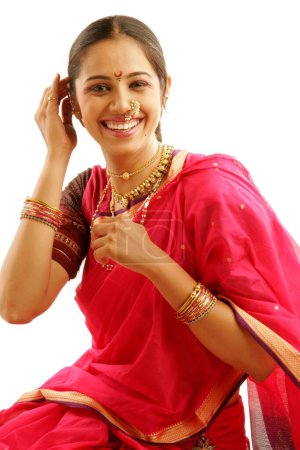 Photo for South Asian Indian Maharashtrian girl wearing traditional navwari nine yard sari with appropriate jewellery happily laughing to ecstasy for what she is wearing - Royalty Free Image