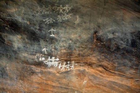 Photo for Cave paintings showing men with arms on rock shelters No 5 ten thousands years old at Bhimbetka near Bhopal , Madhya Pradesh , India - Royalty Free Image