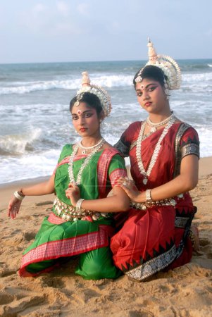 Photo for Dancers performing classical traditional odissi dance in front of bay of Bengal sea, Konarak, Orissa, India - Royalty Free Image