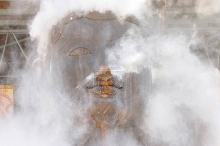 Photo for Sandalwood powder sprinkled on eighteen meter high statue of bhagwan saint gomateshwara bahubali in mahamasthakabhisheka Jain festival , Shravanabelagola in Karnataka , India February_2006 - Royalty Free Image
