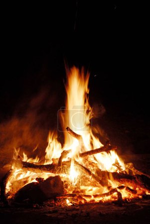 Huge bonfire burning wood fire ignited to celebrate Holi festival , Borivali , Bombay Mumbai , Maharashtra , India