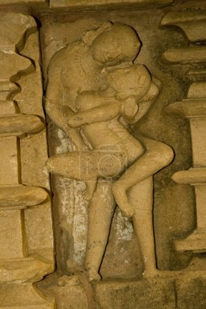 Photo for Erotic sculpture of loving couple at Khandariya Mahadev temple at Khajuraho , Madhya Pradesh , India - Royalty Free Image