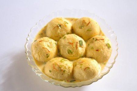 Indian sweet , kesar rasmalai garnish with pistachio and saffron served in bowl