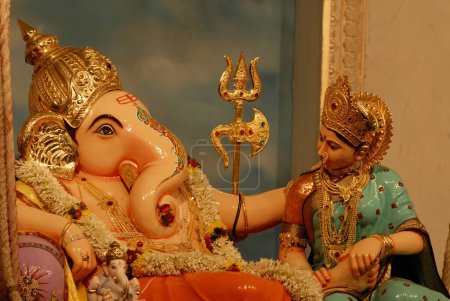 Idol of Lord Ganesh Sitting on Swing as Lord Vishnu with Laxmi elephant Headed worshiping for Ganapati Festival at Mandai , Pune , Maharashtra , India , Asia