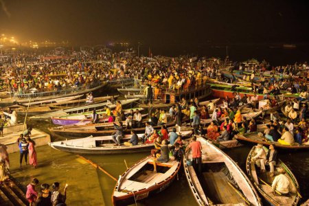 Photo for Tourists sitting in boats to see Ganga Aarti at Dashashwamedh Ghat, Varanasi, Banaras, Benaras, Kashi, Uttar Pradesh, India - Royalty Free Image