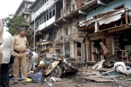 Téléchargez les photos : Des policiers inspectent le site de l'explosion à Zaveri Bazaar dans la zone occupée de Kalbadevi ; Bombay Mumbai, Maharashtra, Inde Le 26 août 2003 - en image libre de droit