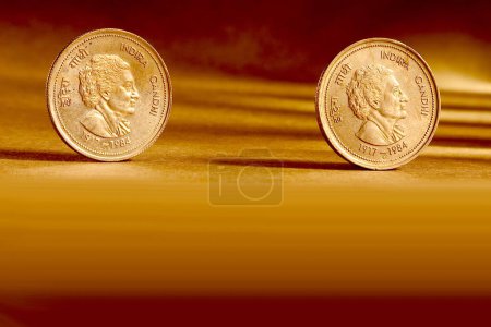 Photo for Double pair Indian currency five rupees coin front side and backside manner embossed Indira Gandhi 1917-1984 on orange background - Royalty Free Image