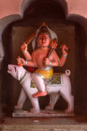 Lord Shiva riding on bull Nandi ; colorful idol  in Kapardikeshwar temple at Otur ; Taluka Junnar ; District Pune ; Maharashtra ; India