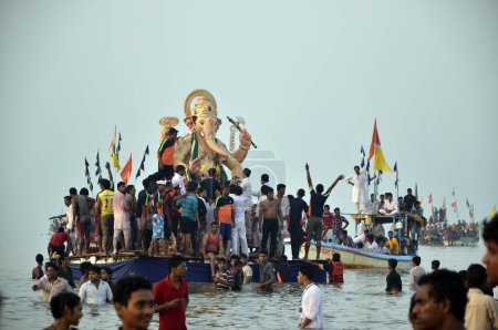 Photo for Devotees are dragging idol of Ganpati on Girgaon Chaupati Mumbai Maharashtra India - Royalty Free Image