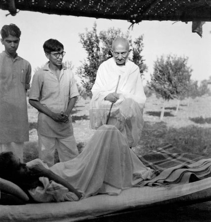 Photo for Mahatma Gandhi talking to a patient at Sevagram Ashram, Vardha, Maharashtra, India, 1941 - Royalty Free Image