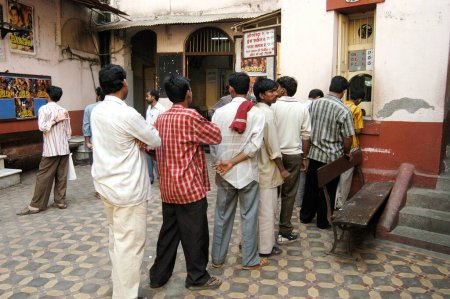 Photo for People standing in queue to purchase cinema tickets at Edward Theatre at Kalbadevi, Bombay Mumbai, Maharashtra, India - Royalty Free Image