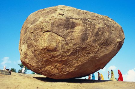 Photo for Krishnas butter ball , rajasthani tourists , dangerously balanced boulder , Mahabalipuram , Tamil nadu , india - Royalty Free Image