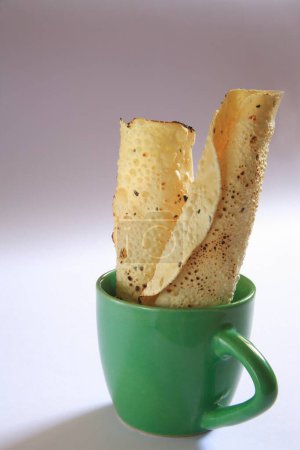 Photo for Roasted papad poppadoms in green cup on white background - Royalty Free Image