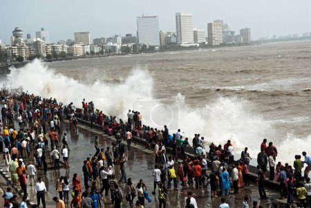 Photo for People enjoying hightide waves at marine drive, Bombay Mumbai, Maharashtra, India - Royalty Free Image
