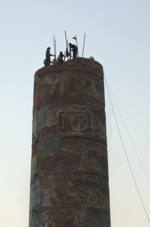 Photo for Workers breaking Elphinstone Mills Chimney, Mumbai, Maharashtra, India, Asia - Royalty Free Image
