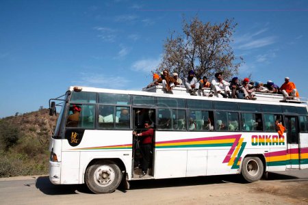 Photo for People travelling sitting on top of bus in Punjab, India - Royalty Free Image