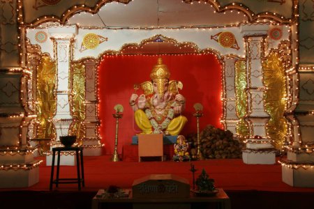 Idol of Lord Ganesh; the elephant headed God ; placed in decorated pandal on Ganesh ganpati festival ; Pune ; Maharashtra ; India